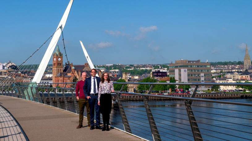 Emma Pollock CTO of FinTrU, Software NI Chief Executive David Crozier, and Chris Clements, Director of Product Development at FinTrU on the Peace Bridge, Derry~Londonderry