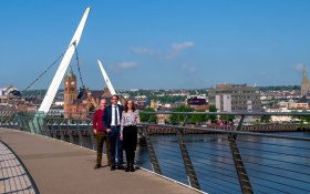 Emma Pollock CTO of FinTrU, Software NI Chief Executive David Crozier, and Chris Clements, Director of Product Development at FinTrU on the Peace Bridge, Derry~Londonderry